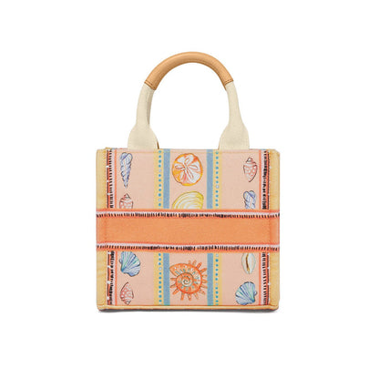 Brighton canvas tote handbag with illustrated seashell print, orange stripes, and tan leather-topped handles on a white background