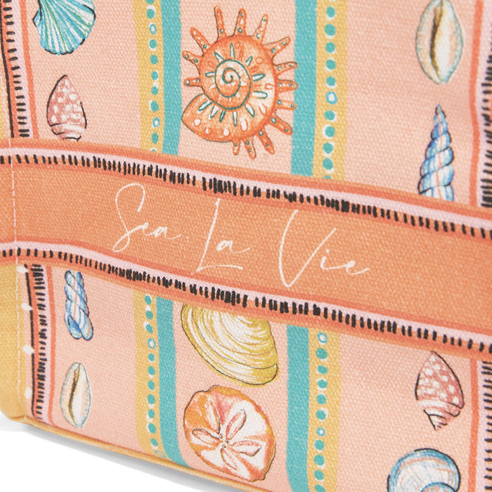Close-up of Brighton canvas tote with illustrated seashell print, striped pattern, and Sea La Vie script text