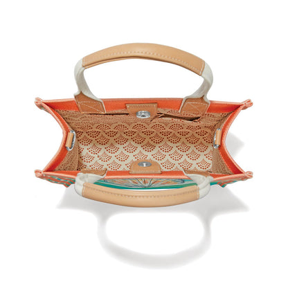 Brighton handbag interior view showing orange lining, patterned inner pocket, tan handles, and magnetic closure on a white background