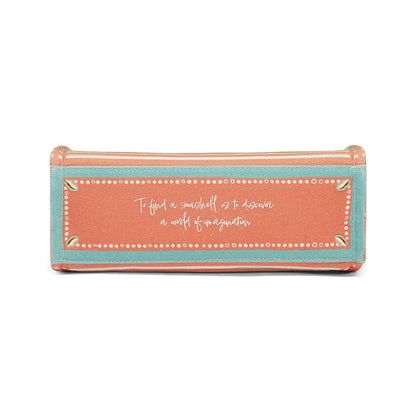 Brighton handbag shown from the bottom with coral and teal panels and printed seashell quote on a white background