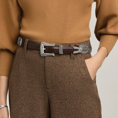 Model wearing a Brighton brown leather belt with ornate silver-tone engraved buckle, keeper, and tip