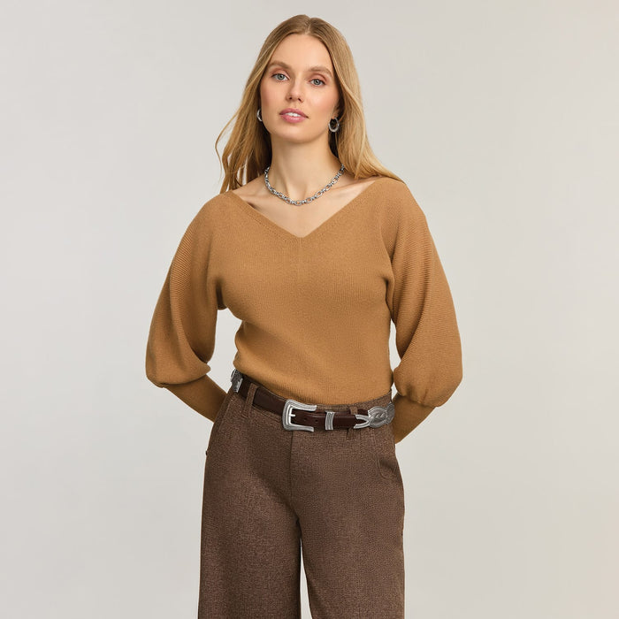 Model wearing a Brighton brown leather belt with ornate silver-tone buckle and keeper details on wide-leg trousers