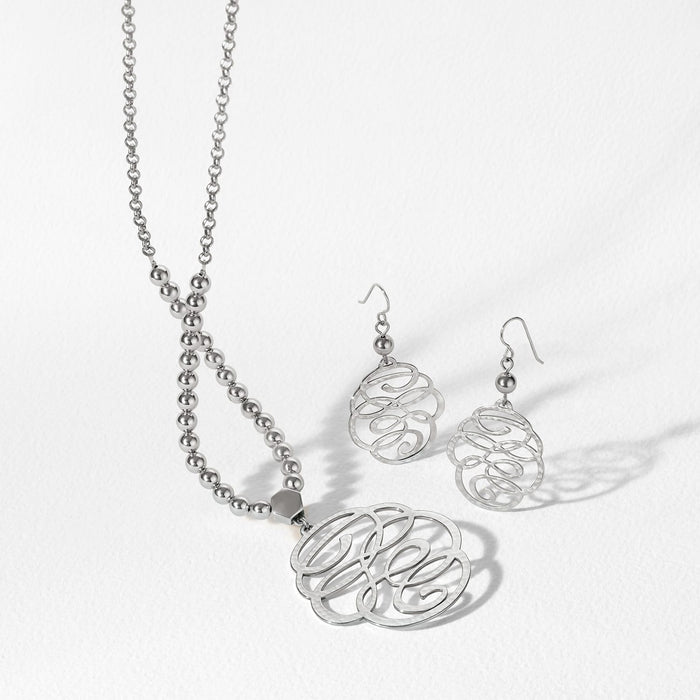 Brighton silver-plated monogram pendant necklace with beaded chain and matching hammered scroll drop earrings on a white background