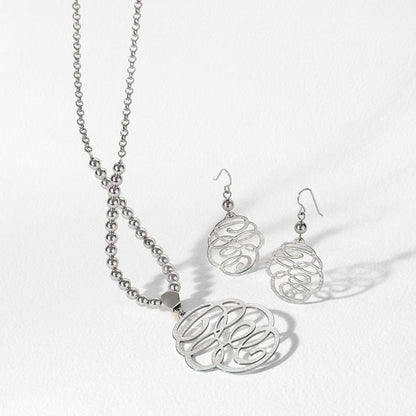 Brighton silver-plated monogram pendant necklace with beaded chain and matching hammered scroll drop earrings on a white background