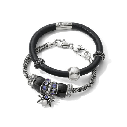 Brighton bracelets with black leather band, silver-plated mesh chain, crystal charms, and spider pendant on a white background