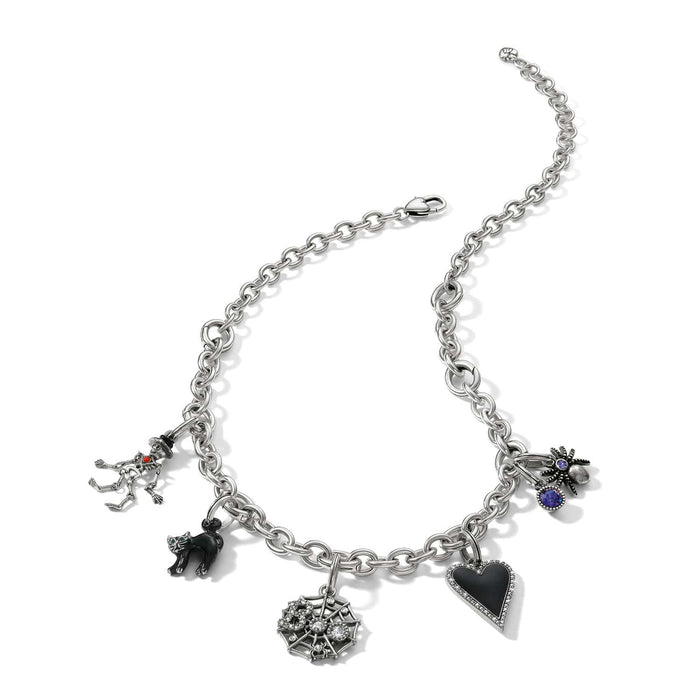 Brighton silver-plated charm necklace with skeleton, black cat, spider web, spider, and black heart charms on a white background