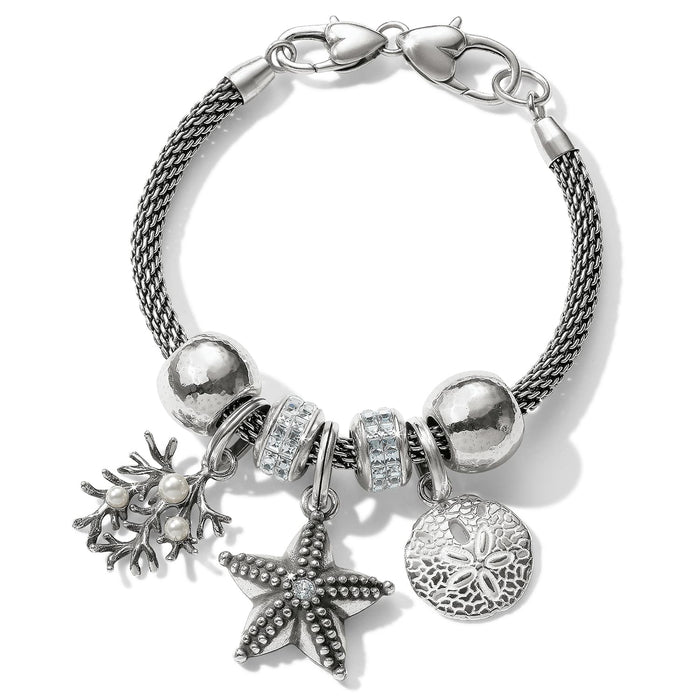 Brighton charm bracelet with silver-plated starfish, sand dollar, coral with glass pearls, and crystal beads on a white background