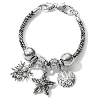 Brighton charm bracelet with silver-plated starfish, sand dollar, coral with glass pearls, and crystal beads on a white background