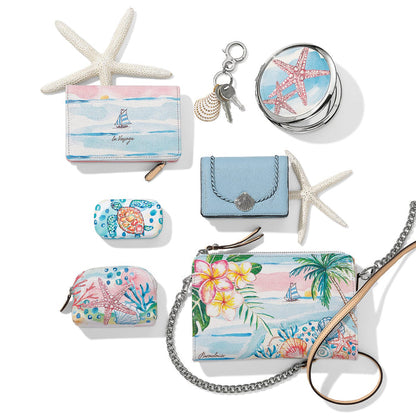 Brighton coastal accessories collection styled with starfish and seashell keychain, featuring watercolor tropical and ocean prints