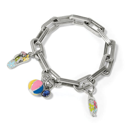 Brighton charm bracelet with silver-tone link chain, enamel flip-flop, beach ball, and surfboard charms on a white background