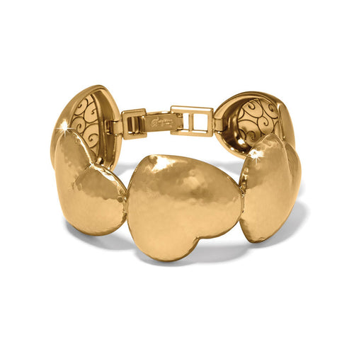 Brighton bracelet with hammered gold-plated heart-shaped links and decorative scrollwork clasp on a white background