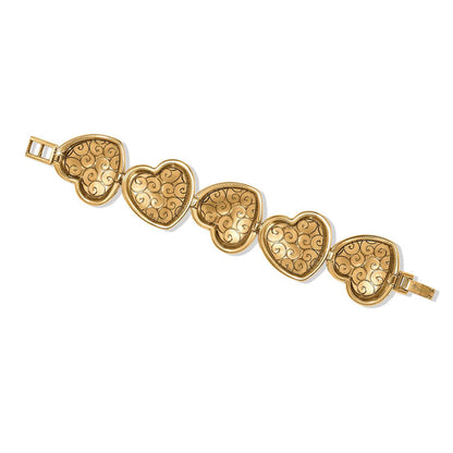 Brighton bracelet shown from the back with five gold-plated heart links featuring swirl patterns on a white background