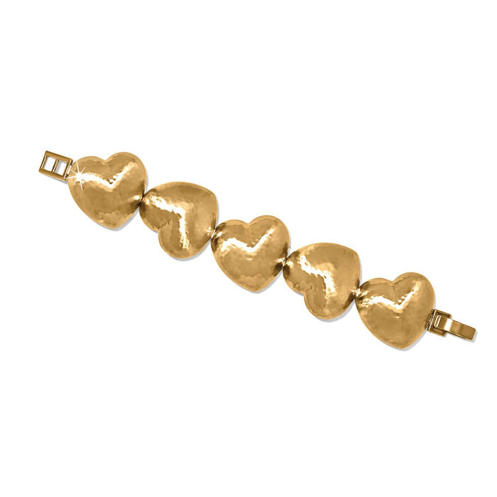 Brighton bracelet with five gold-plated hammered heart-shaped links and fold-over clasp on a white background
