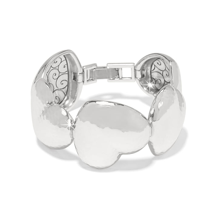 Brighton bracelet with hammered silver-plated heart-shaped links and scroll detailing on the interior on a white background