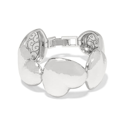 Brighton bracelet with hammered silver-plated heart-shaped links and scroll detailing on the interior on a white background