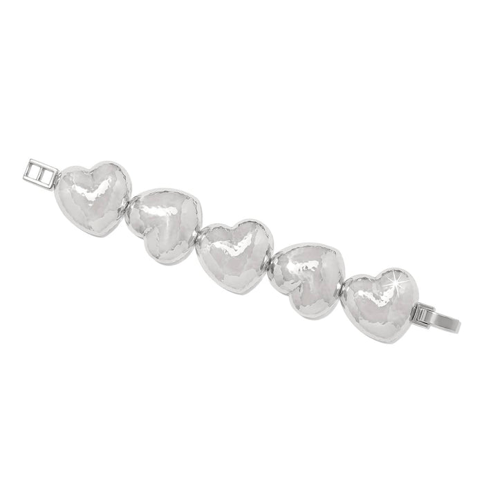 Brighton bracelet with five hammered silver-plated puffed heart links and hinged clasp on a white background