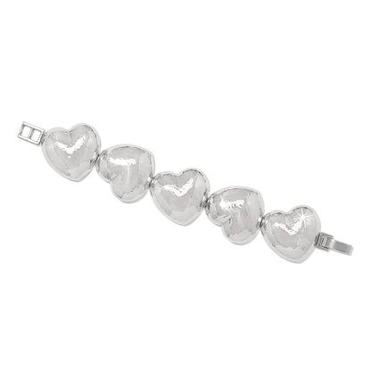 Brighton bracelet with five hammered silver-plated puffed heart links and hinged clasp on a white background