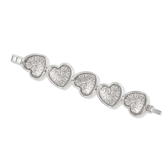 Brighton bracelet shown from the back with five silver-plated heart-shaped links featuring scroll patterns on a white background