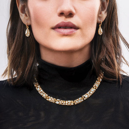 Model wearing a Brighton gold-plated crystal collar necklace paired with matching gold-plated teardrop crystal drop earrings
