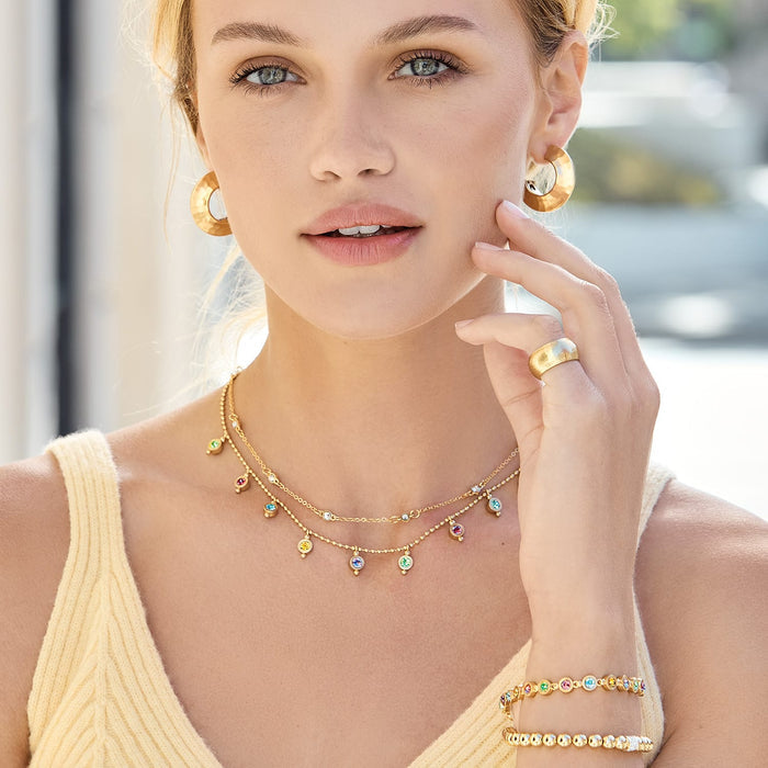 Model wearing Brighton gold-plated layered necklace with multicolor crystal drops and coordinating Brighton accessories