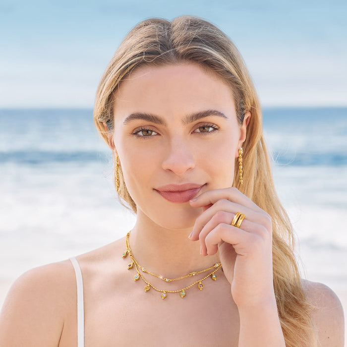 Model wearing Brighton gold-plated layered necklace with crystal charms and coordinating Brighton accessories