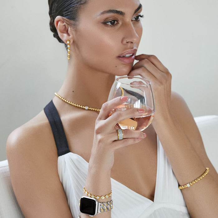 Model wearing a Brighton gold-plated beaded necklace with crystal accent and coordinating Brighton accessories