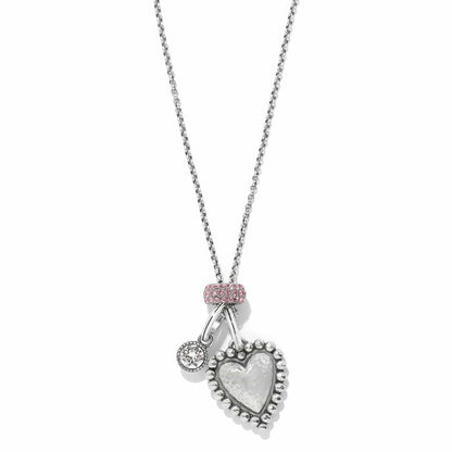 Brighton pendant necklace with hammered silver-plated heart, crystal charm, and pink crystal bail on a white background