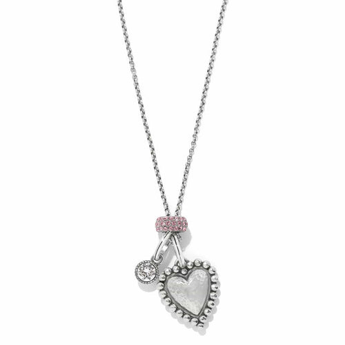 Brighton pendant necklace with hammered silver-plated heart, crystal charm, and pink crystal bail on a white background