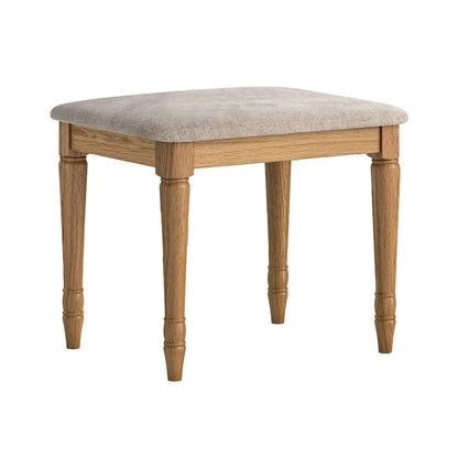 Wooden dressing table stool with an oatmeal cushioned top on a white background