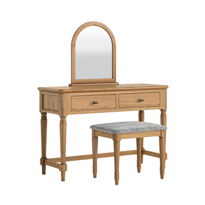 Wooden vanity table with mirror and stool with grey cushion on a white background