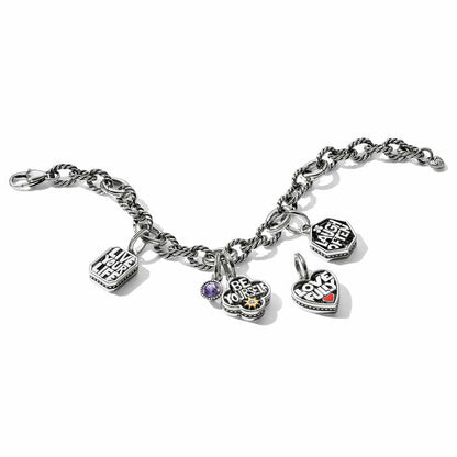 Brighton charm bracelet with two-tone message charms, purple crystal, and heart accents on a white background