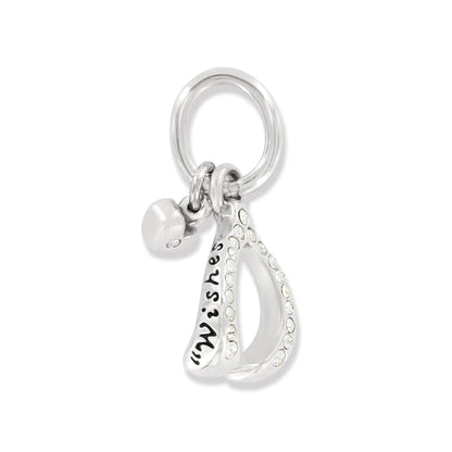 Brighton wishbone charm with silver-plated finish, crystal accents, engraved Wishes detail, and heart charm on a white background