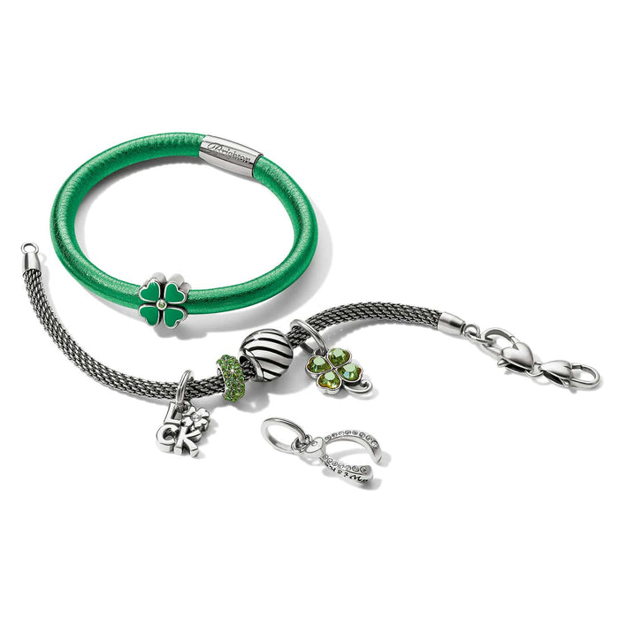 Brighton bracelets styled with silver-plated clover charms and horseshoe pendant featuring green enamel and crystal accents