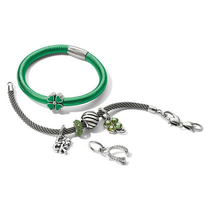 Brighton bracelets styled with silver-plated clover charms and horseshoe pendant featuring green enamel and crystal accents