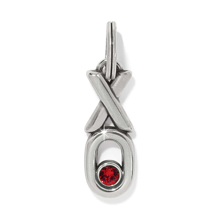 Brighton silver-plated charm with XO design and red crystal accent in the O on a white background